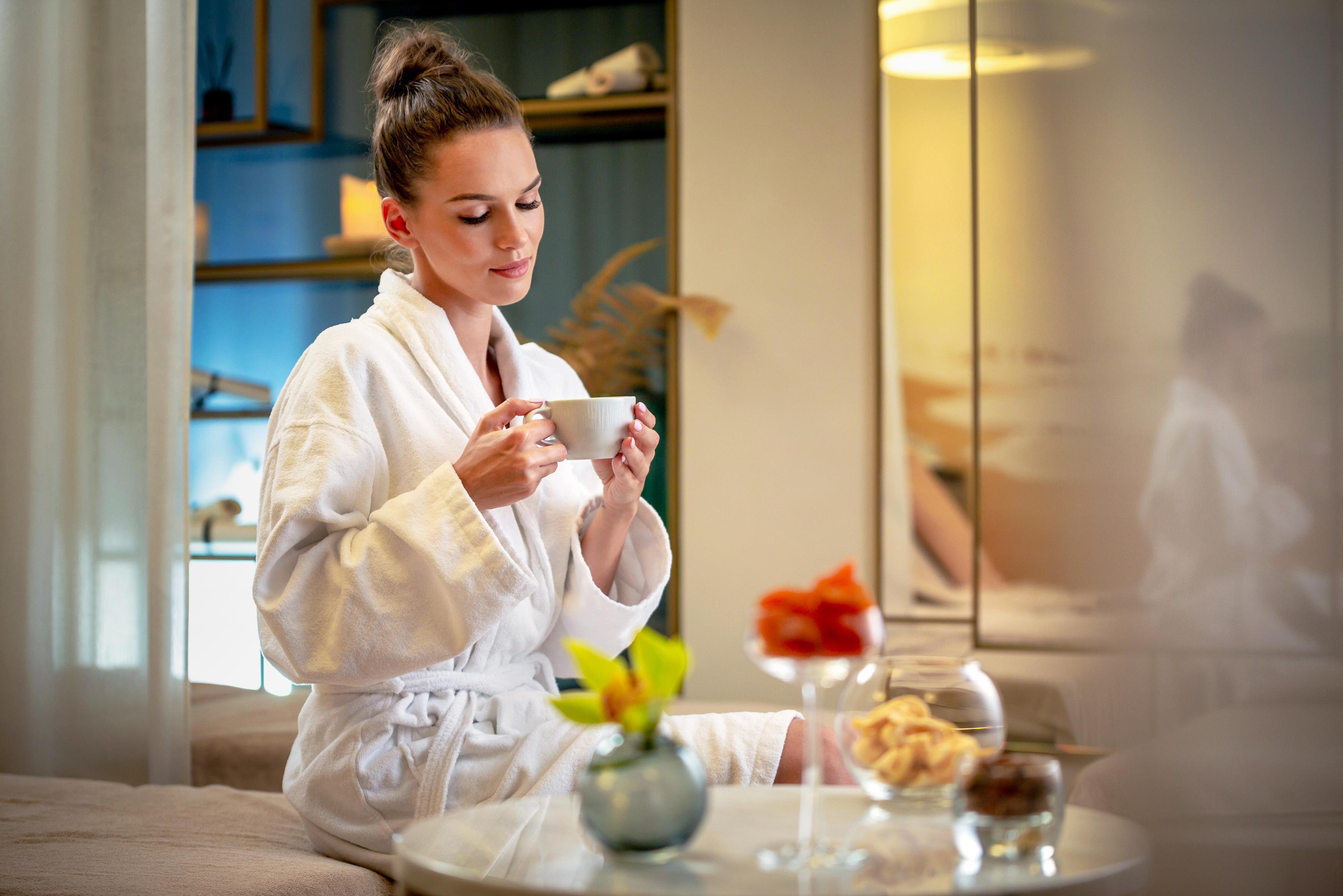Grand Poet Hotel And Spa By Semarah Рига Екстериор снимка A woman wearing a bathrobe