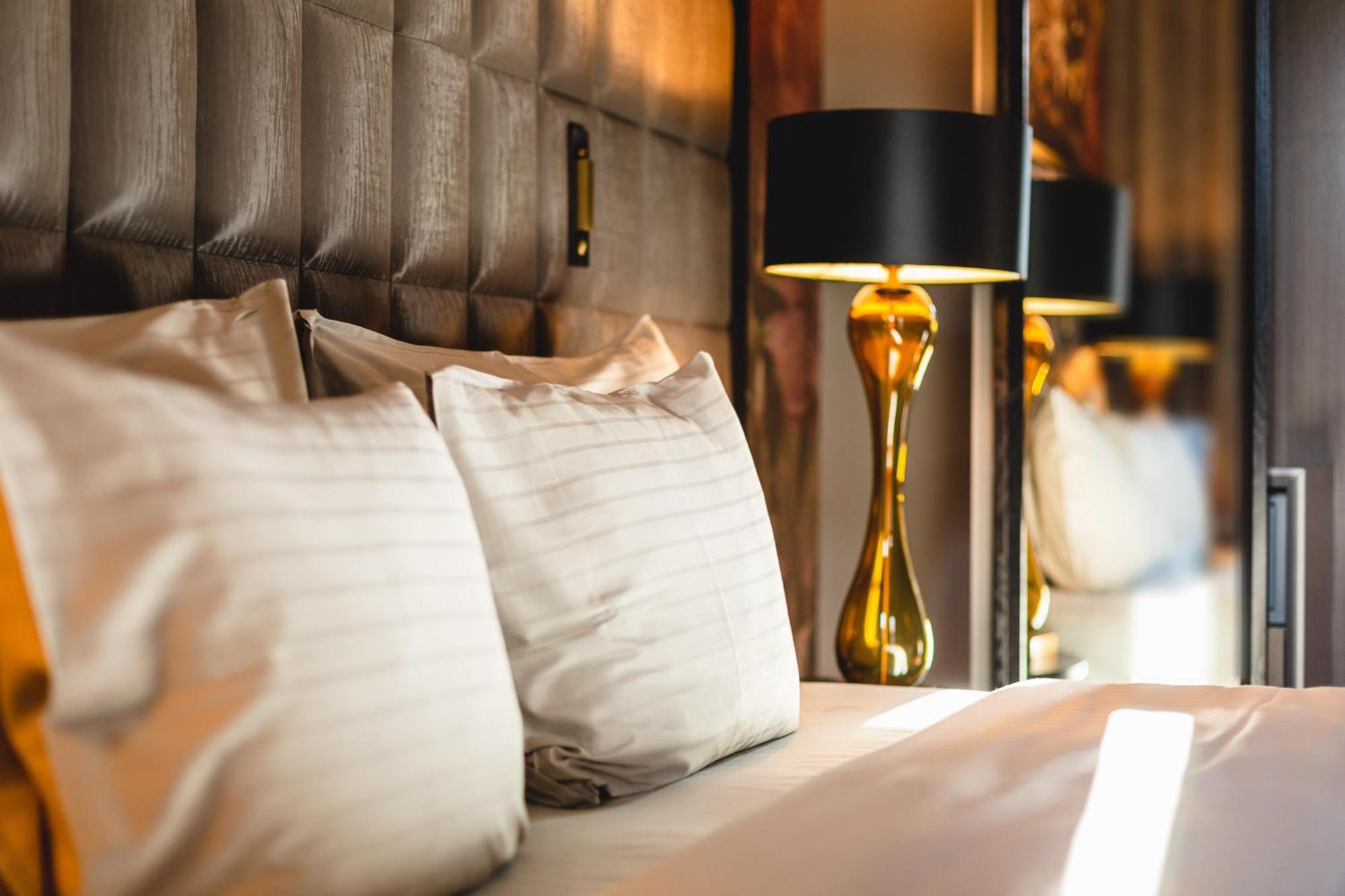 Grand Poet Hotel And Spa By Semarah Рига Екстериор снимка A bed with pillows