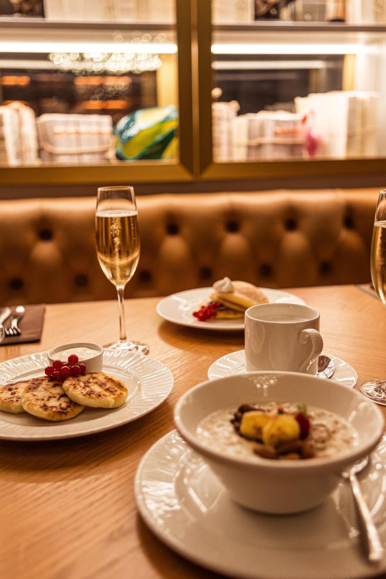 Grand Poet Hotel And Spa By Semarah Рига Екстериор снимка A glass of champagne